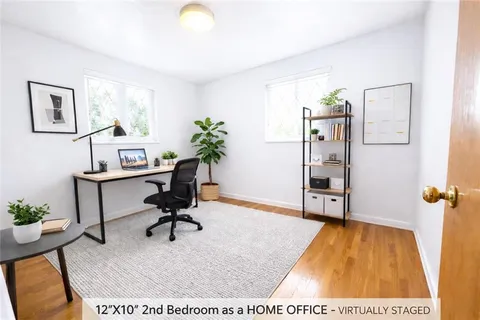 a workspace with furniture and a potted plant