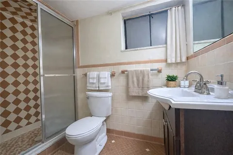 a bathroom with a sink toilet and shower