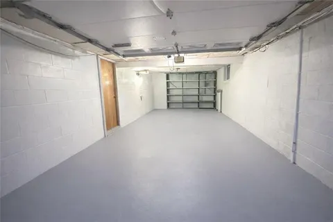 a room with pool table and windows