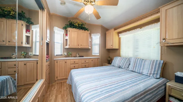 a bedroom with a bed and wooden floor