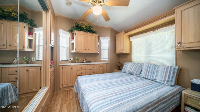 a bedroom with a bed and wooden floor
