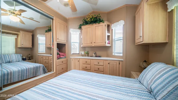 a view of a patio with table and chairs and floor to ceiling window with wooden floor