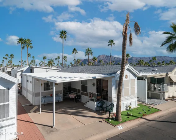 a view of a patio with table and chairs near a yard