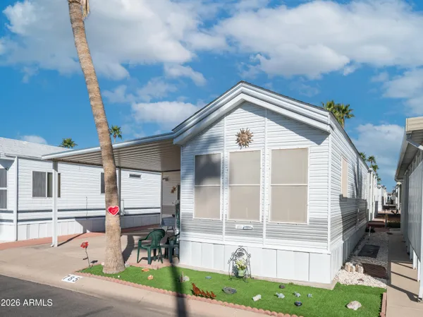 a front view of a house with outdoor seating