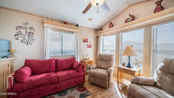 a living room with furniture ceiling fan and a window