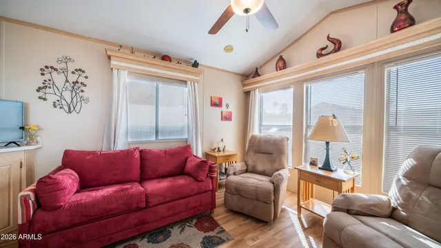 a living room with furniture ceiling fan and a window