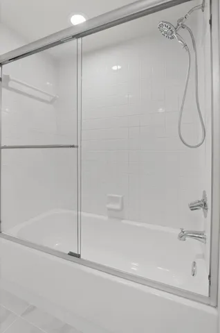 a view of a porch with a floor to ceiling window next to a yard