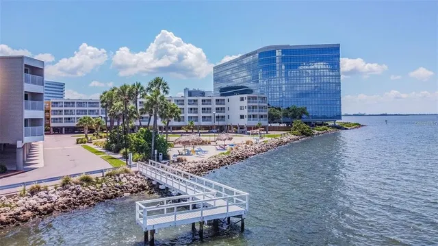 a view of multiple houses with a yard and potted plants