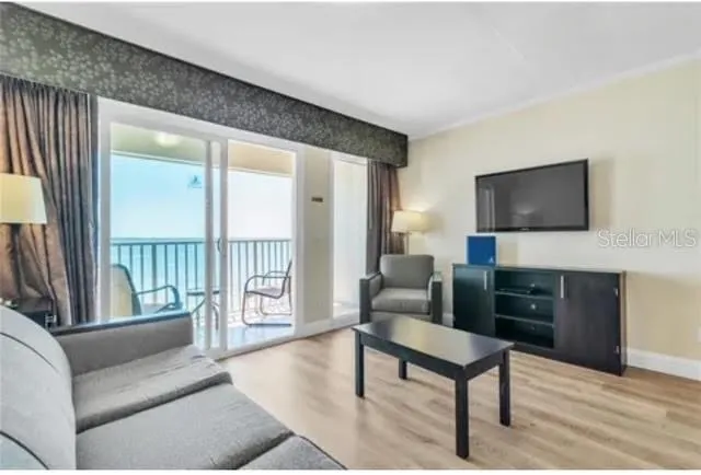 a living room with furniture and a flat screen tv