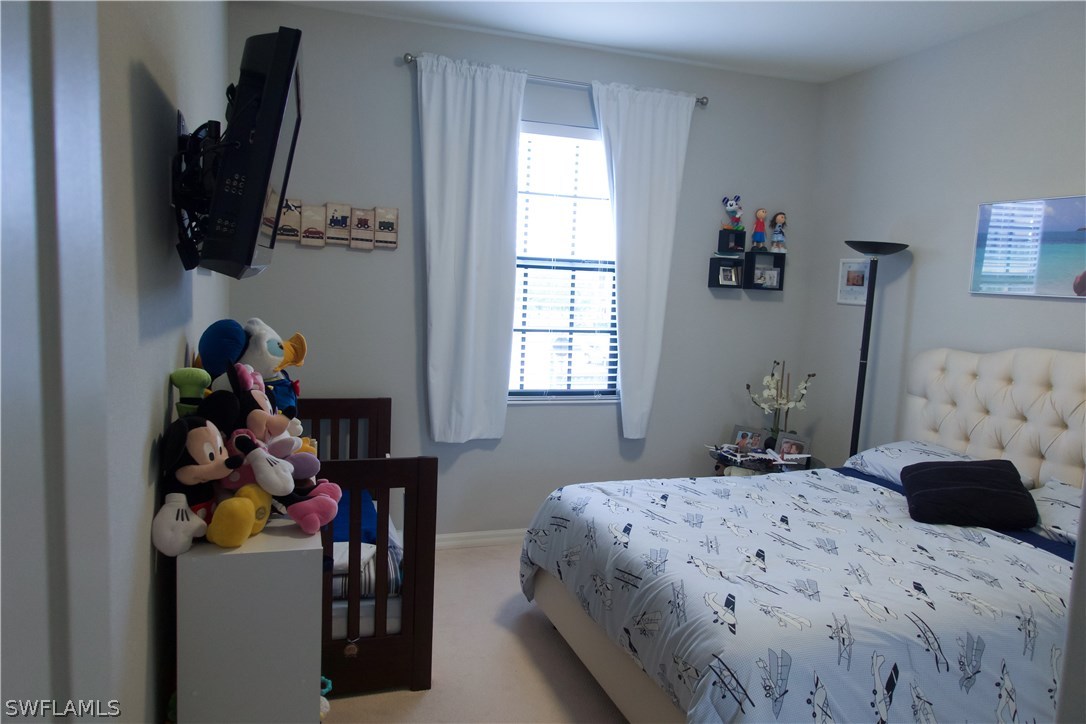 11845 Palba Way, Unit 7301 Fort Myers, FL 33912 - Photo 17 of 19 a bedroom with a bed and a window