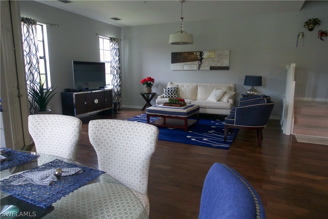11845 Palba Way, Unit 7301 Fort Myers, FL 33912 - Photo 4 of 19 a living room with furniture a flat screen tv and a window