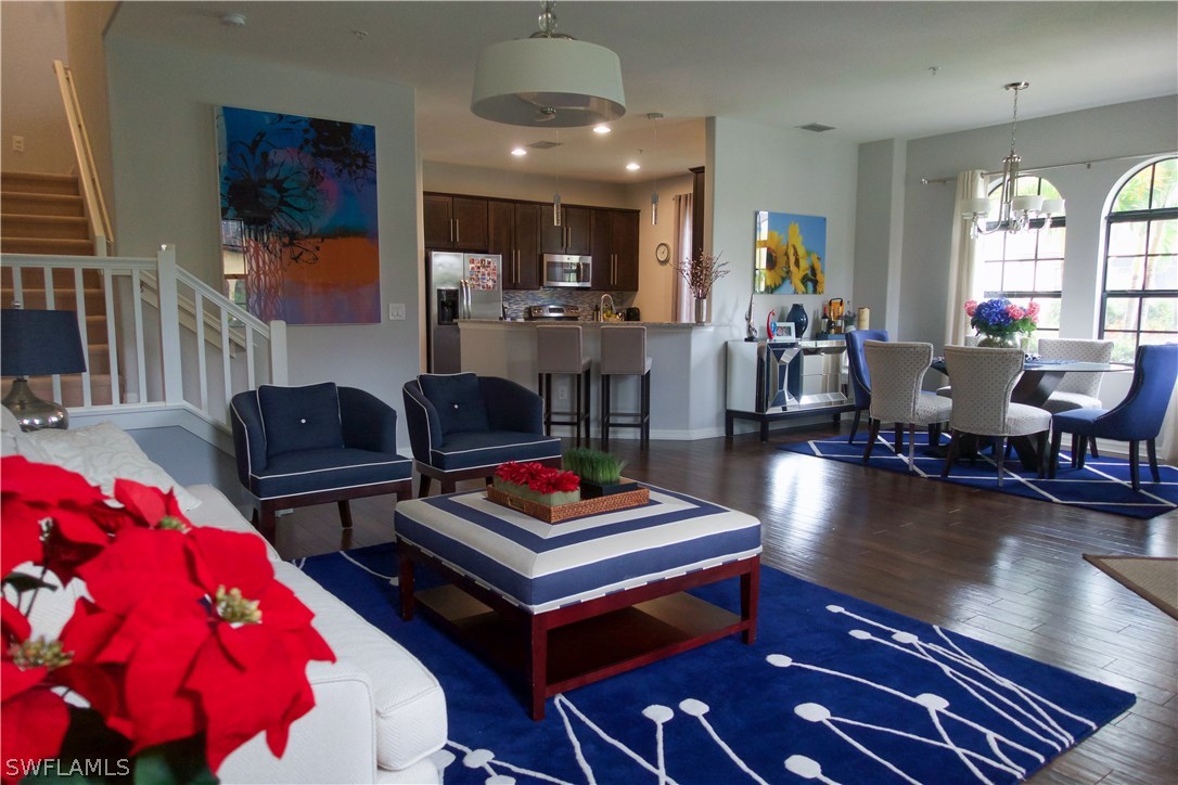11845 Palba Way, Unit 7301 Fort Myers, FL 33912 - Photo 5 of 19 a living room with furniture a dining table and kitchen view