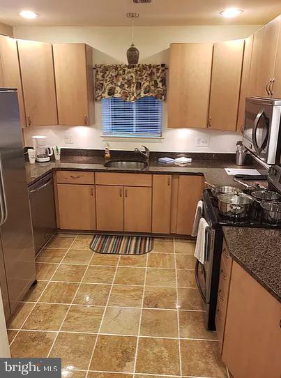 1018 Booth Street Baltimore, MD 21223 - Photo 2 of 6 a kitchen with a sink a stove and cabinets