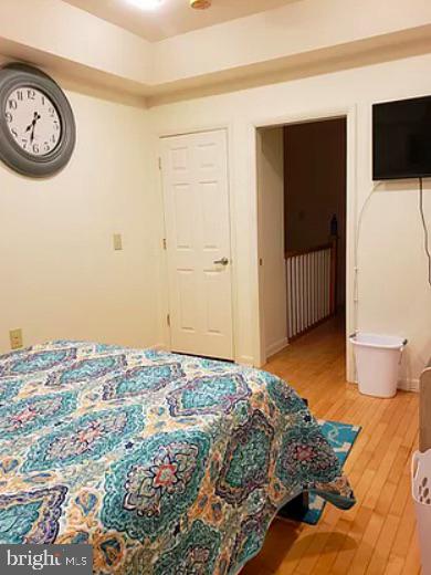 1018 Booth Street Baltimore, MD 21223 - Photo 5 of 6 a bedroom with a bed and a television