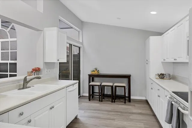 a kitchen with sink cabinets and wooden floor