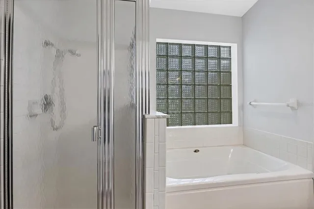 a bathroom with a bathtub and shower