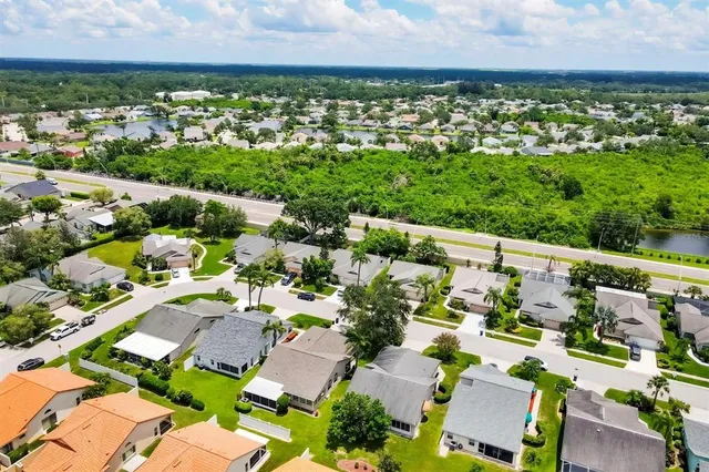 an aerial view of residential houses with outdoor space