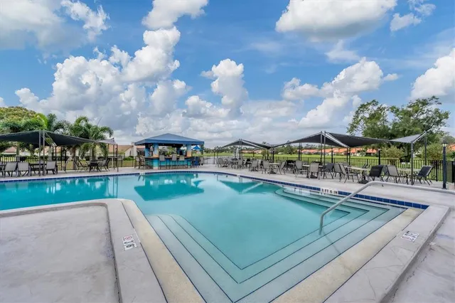 a view of swimming pool with outdoor seating