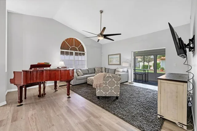 a living room with furniture and a wooden floor