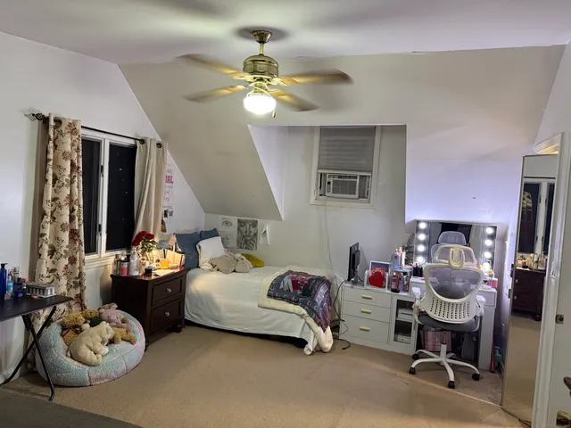 a bed room with a bed and a mirror