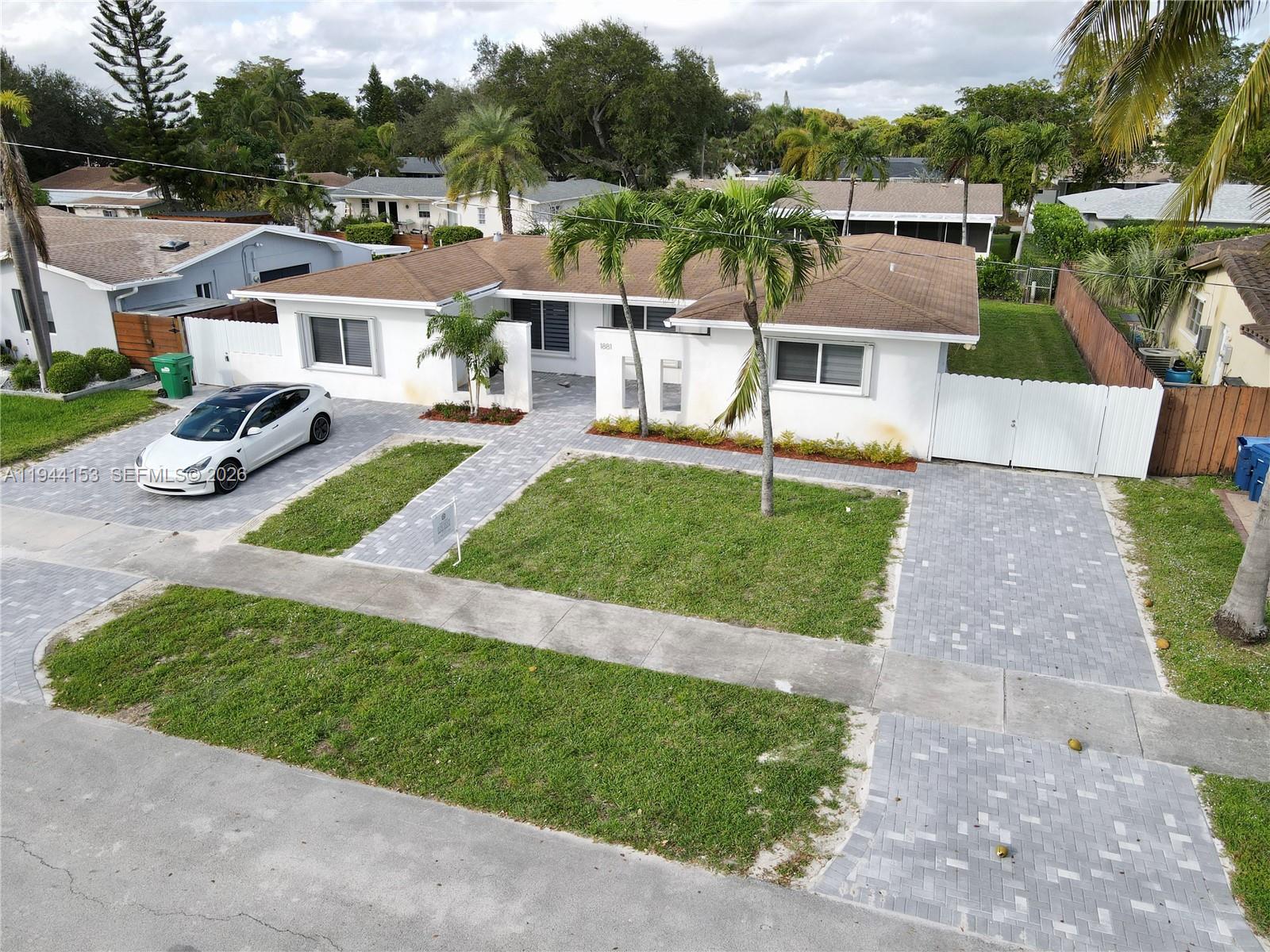 a view of a house with a yard and sitting area