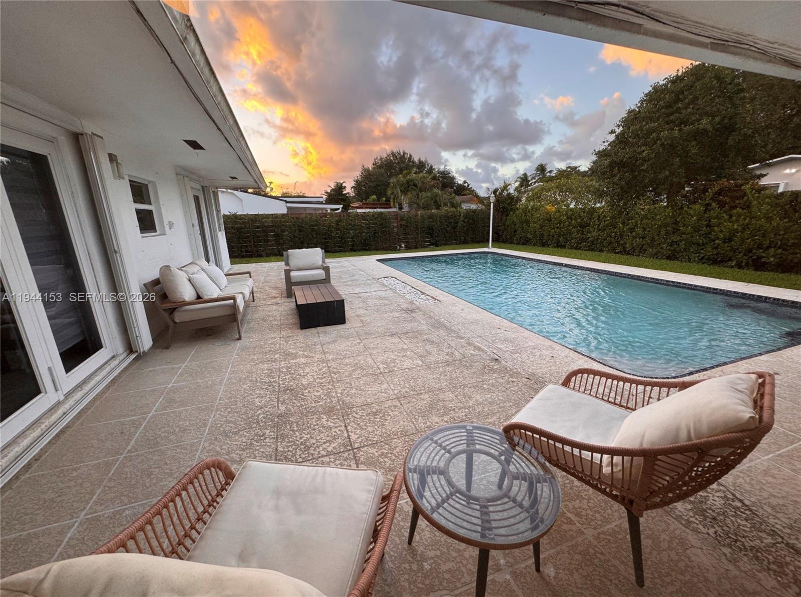 1881 Northeast 210th Street Miami, FL 33179 - Photo 11 of 29 a view of a terrace with couches and sky view