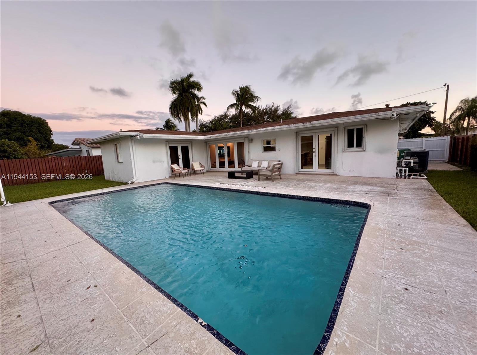 1881 Northeast 210th Street Miami, FL 33179 - Photo 13 of 29 a front view of a house with a garden and yard