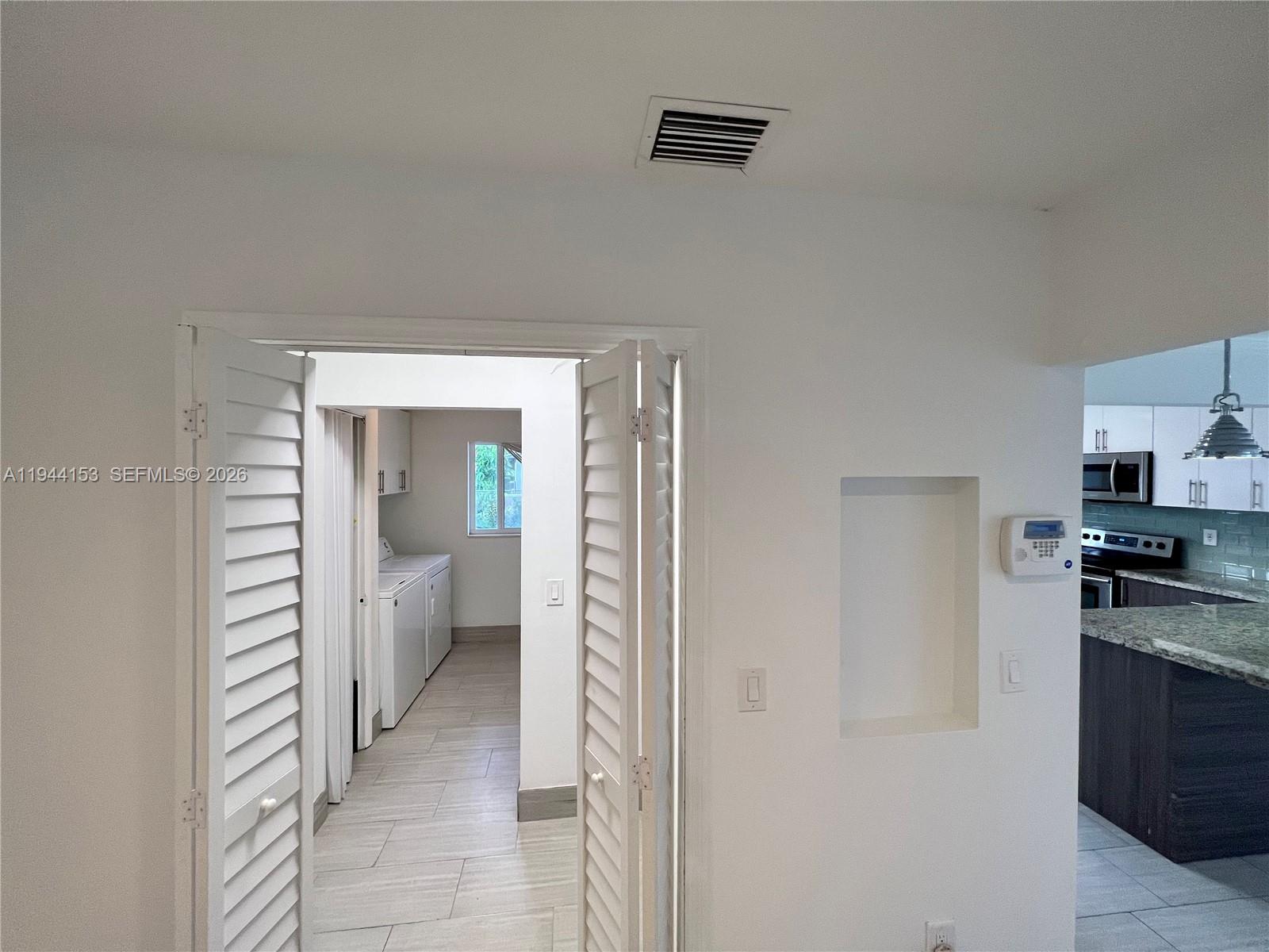 1881 Northeast 210th Street Miami, FL 33179 - Photo 18 of 29 a view of a kitchen from the hallway