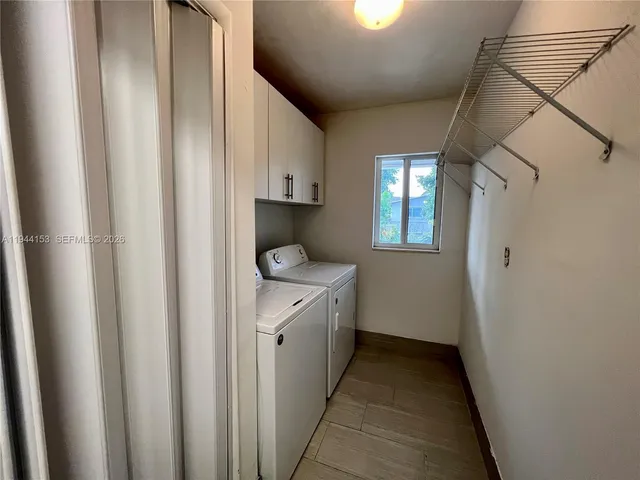 a kitchen with stainless steel appliances granite countertop a sink counter space cabinets and a large window