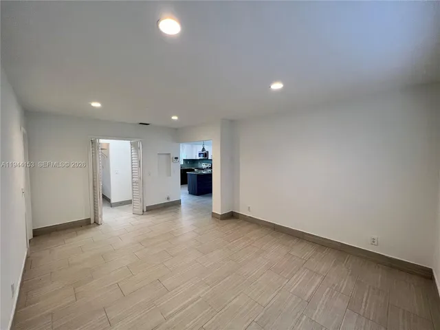 a view of a patio with table and chairs in front of house