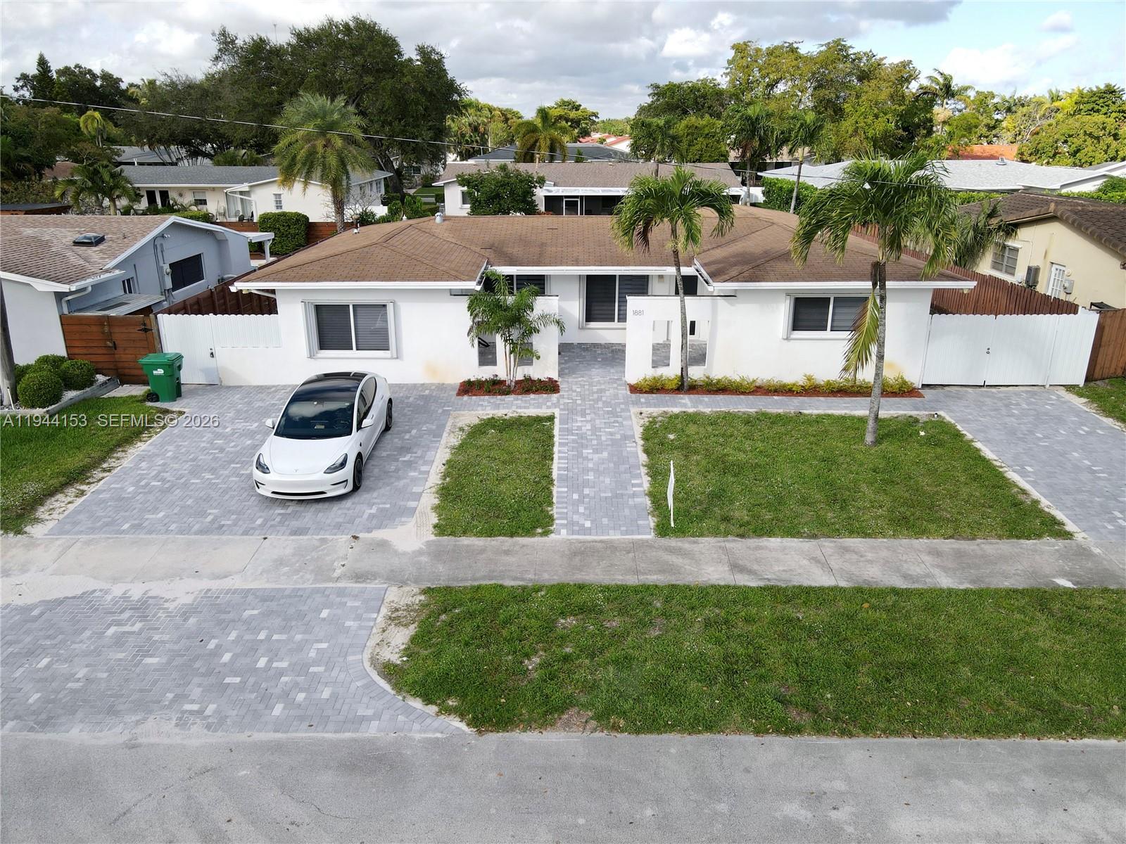 1881 Northeast 210th Street Miami, FL 33179 - Photo 29 of 29 an aerial view of residential houses with outdoor space and parking