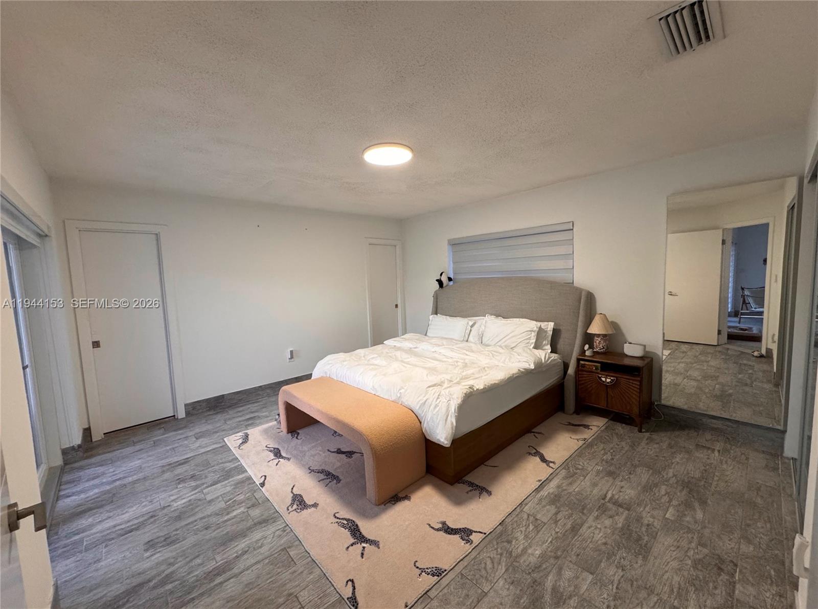 1881 Northeast 210th Street Miami, FL 33179 - Photo 6 of 29 a bed room with a bed and a night stand