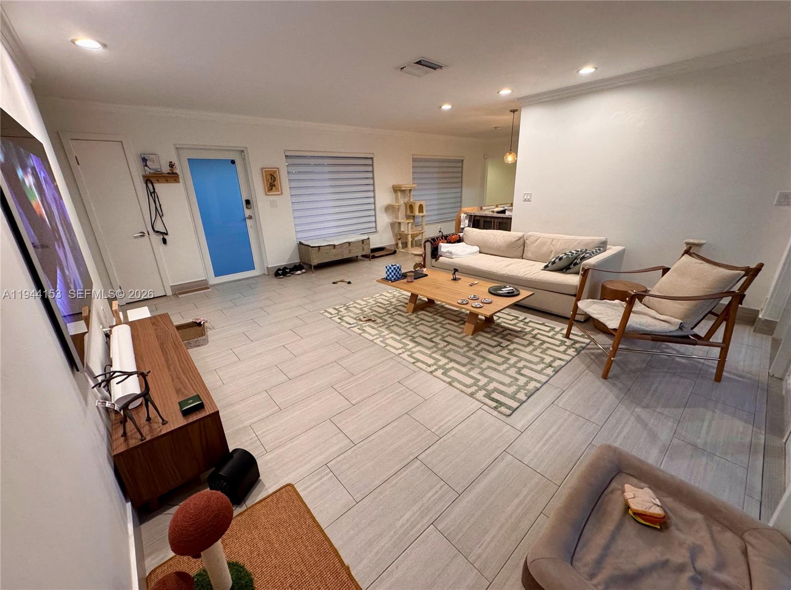 1881 Northeast 210th Street Miami, FL 33179 - Photo 7 of 29 a living room with furniture rug and a window