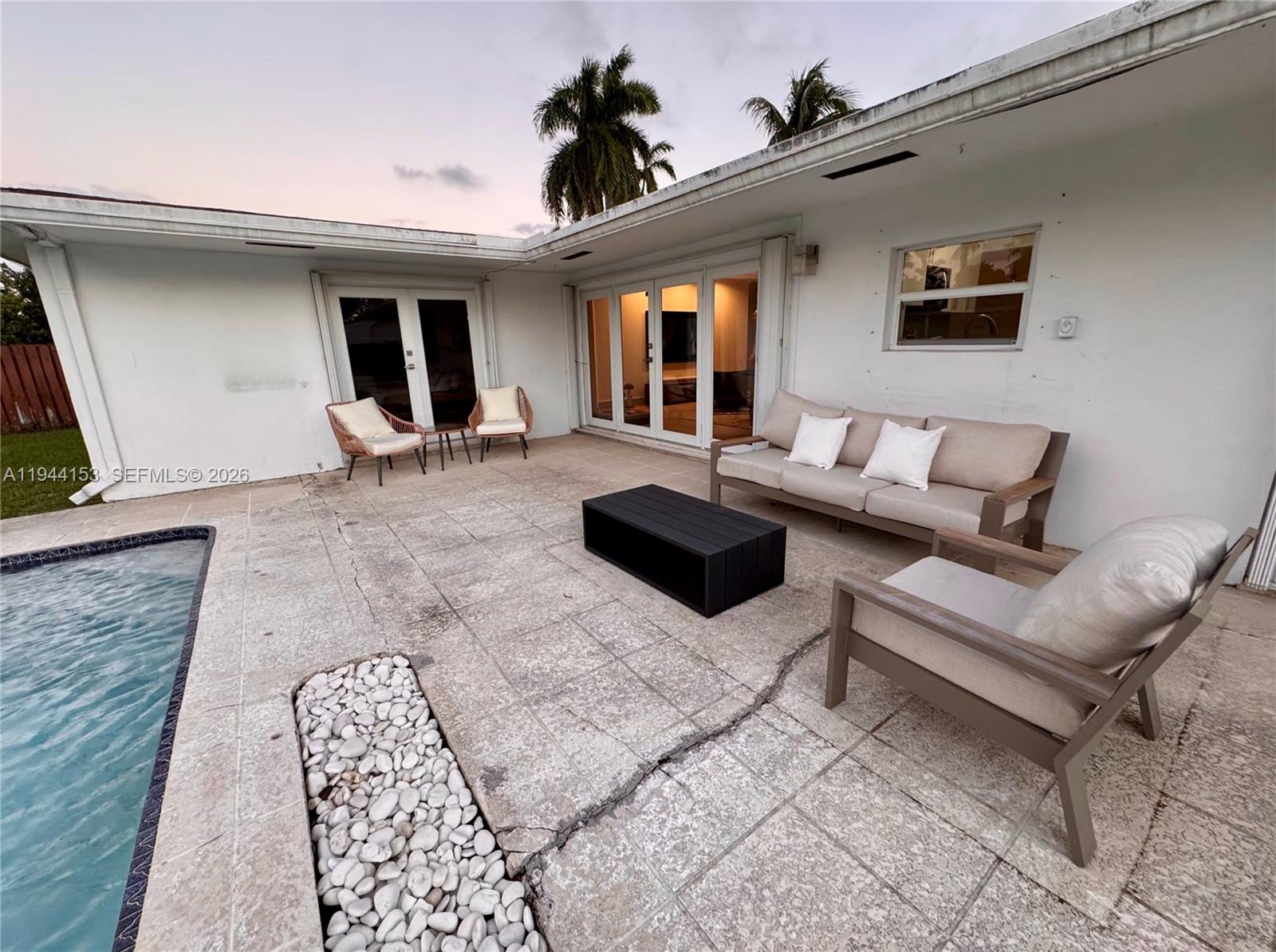1881 Northeast 210th Street Miami, FL 33179 - Photo 10 of 29 a living room with furniture and a window