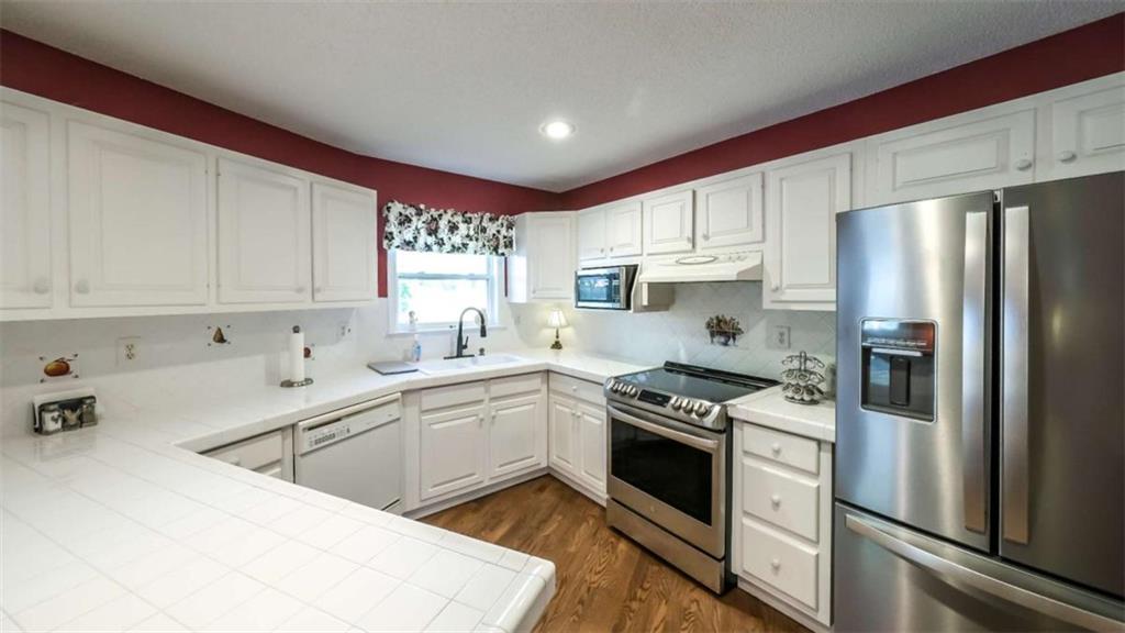 396 Pam Street Wedowee, AL 36278 - Photo 12 of 48 a kitchen with stainless steel appliances granite countertop a sink stove and refrigerator