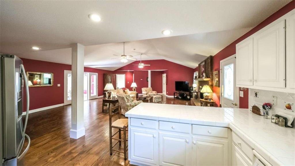 396 Pam Street Wedowee, AL 36278 - Photo 13 of 48 a view of a kitchen with kitchen island a large counter space a sink appliances and cabinets