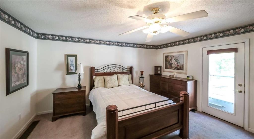 396 Pam Street Wedowee, AL 36278 - Photo 16 of 48 a bed room with a bed and a chandelier