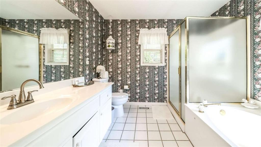 396 Pam Street Wedowee, AL 36278 - Photo 18 of 48 a bathroom with a sink and mirror with bathtub