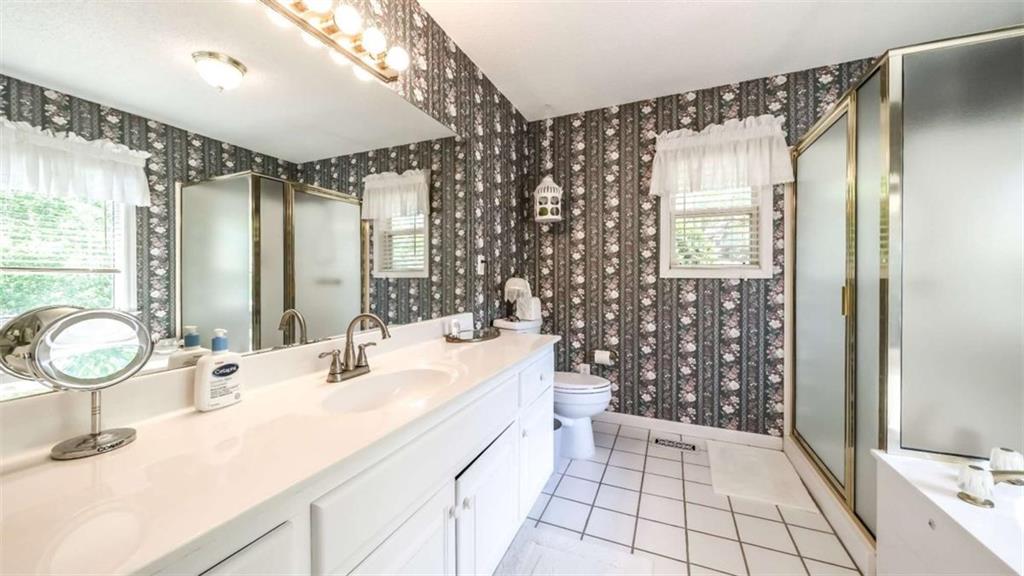 396 Pam Street Wedowee, AL 36278 - Photo 19 of 48 a bathroom with a double vanity sink mirror and shower