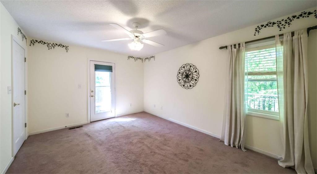 396 Pam Street Wedowee, AL 36278 - Photo 22 of 48 an empty room with windows and fan