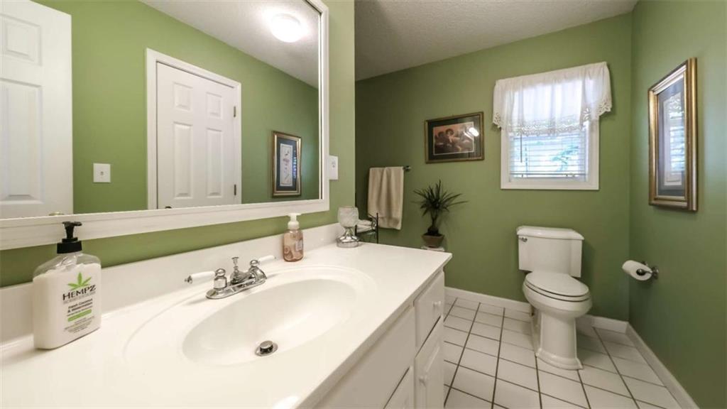 396 Pam Street Wedowee, AL 36278 - Photo 24 of 48 a bathroom with a sink a toilet and mirror