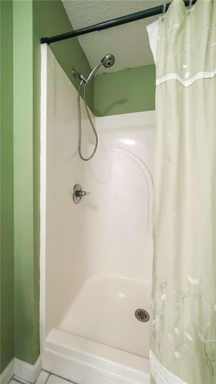 396 Pam Street Wedowee, AL 36278 - Photo 25 of 48 a bathroom with a glass shower door