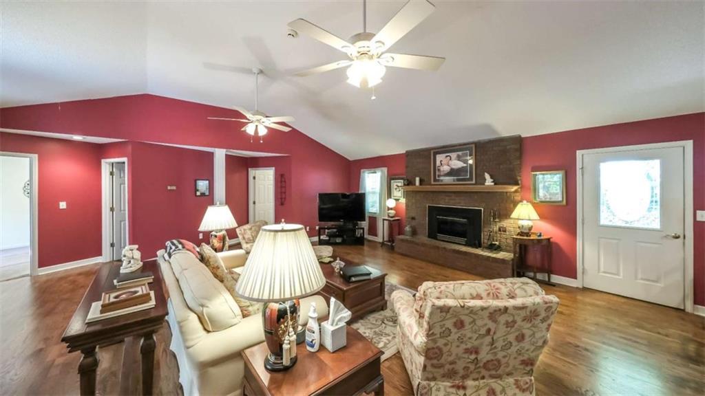 396 Pam Street Wedowee, AL 36278 - Photo 7 of 48 a living room with furniture a fireplace and a window