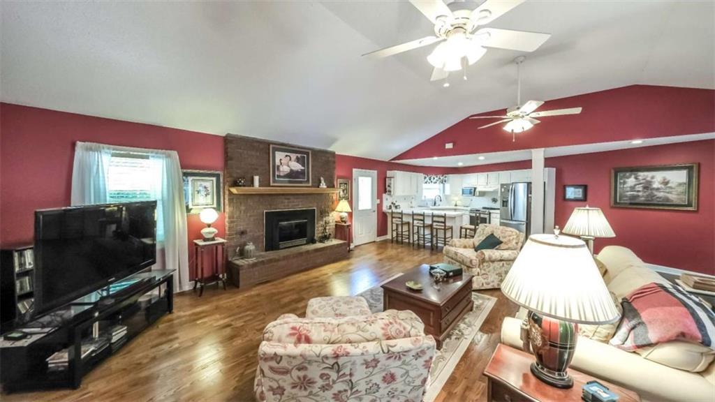 396 Pam Street Wedowee, AL 36278 - Photo 8 of 48 a living room with furniture a flat screen tv and a fireplace