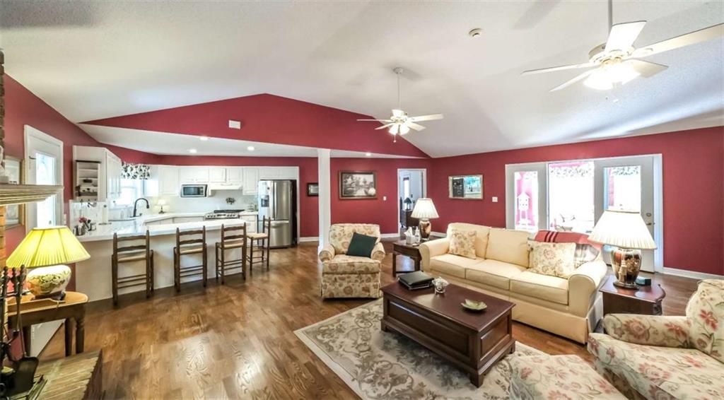 396 Pam Street Wedowee, AL 36278 - Photo 10 of 48 a living room with furniture a dining table and kitchen view