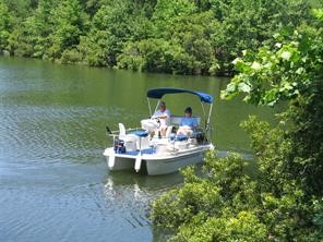 37 Robin Hood Cleveland, TX 77327 - Photo 14 of 20 a view of a lake with a table and chairs in roof deck