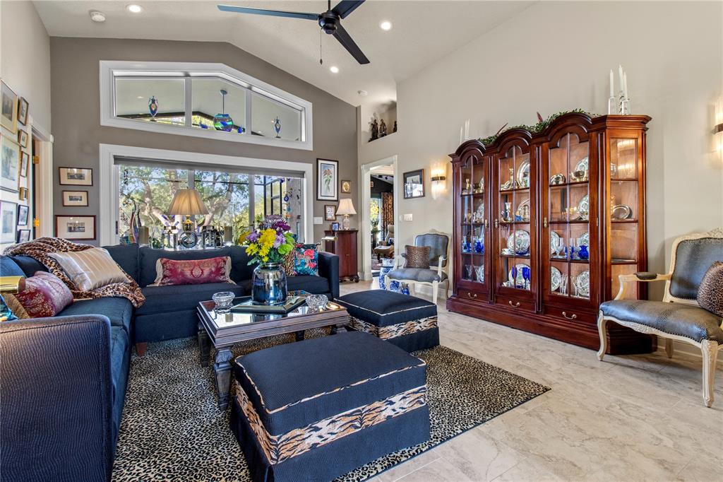 70 Center Oak Circle Spring Hill, FL 34609 - Photo 21 of 58 a living room with furniture a chandelier and a flat screen tv