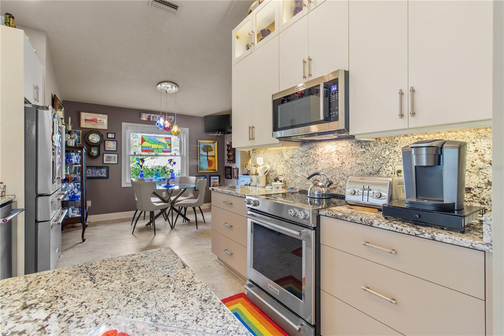 70 Center Oak Circle Spring Hill, FL 34609 - Photo 23 of 58 a kitchen with stainless steel appliances granite countertop a stove and a sink
