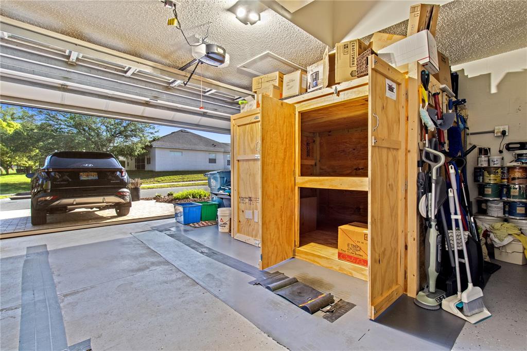 70 Center Oak Circle Spring Hill, FL 34609 - Photo 40 of 58 a view of a car park with furniture and a garage