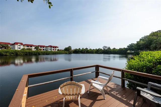 a view of a balcony with chair and wooden floor